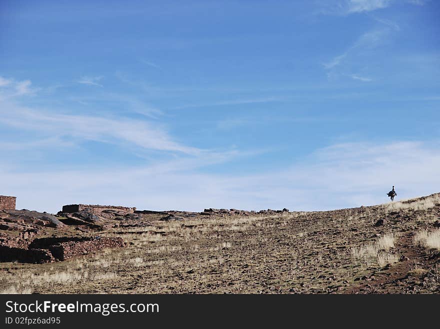 Boy is riding his donkey in the mountains of Morocco. Boy is riding his donkey in the mountains of Morocco