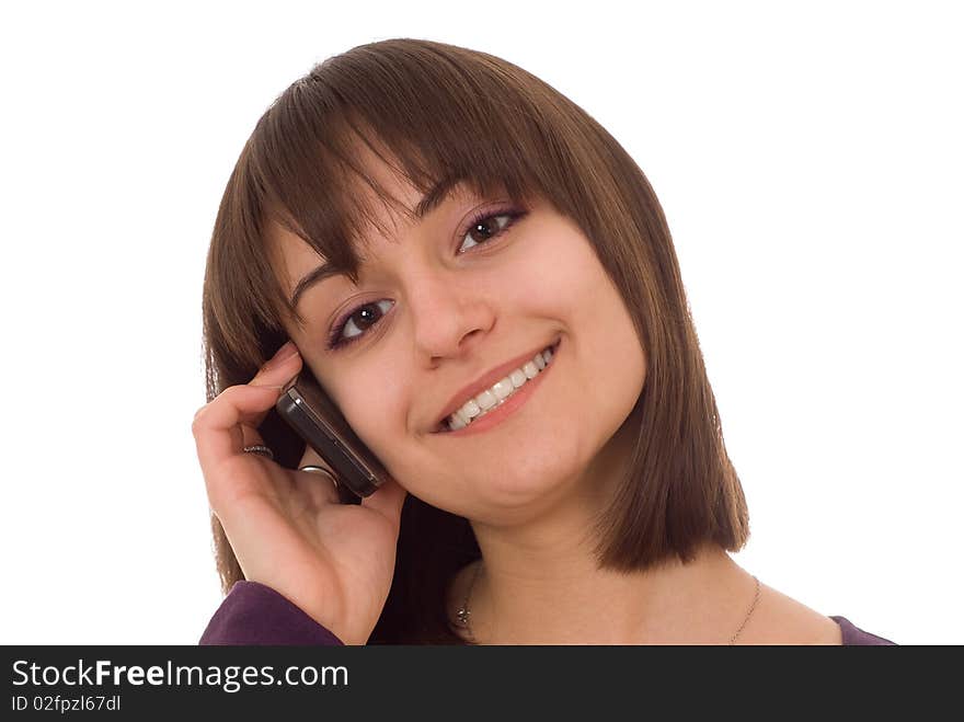 Young pretty girl standing with a phone on a white background