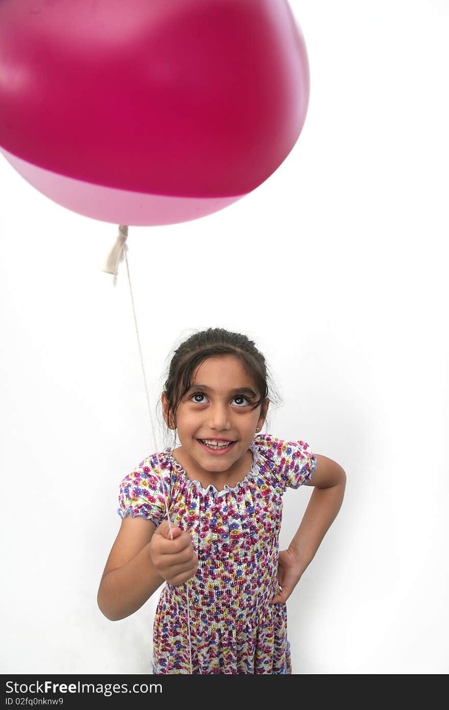 The little girl is happy with balloons in hand. The little girl is happy with balloons in hand