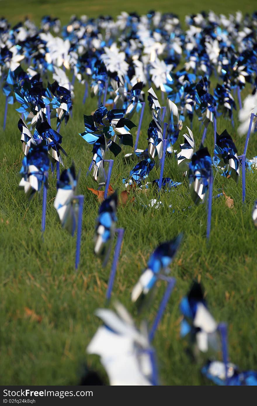 Blue and silver pinwheels blowing in the wind.