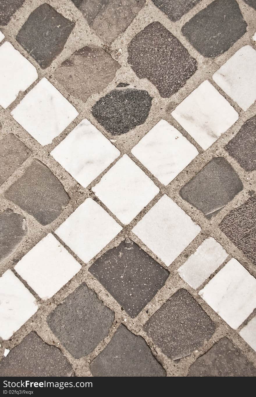 X letter on a pavement made from stones