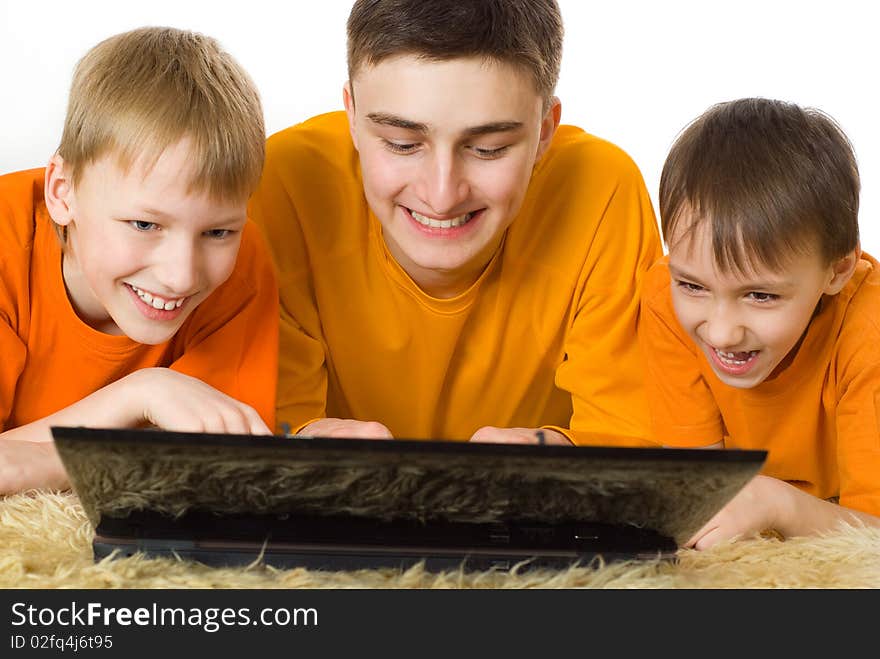 Three Brothers Looking At Laptop