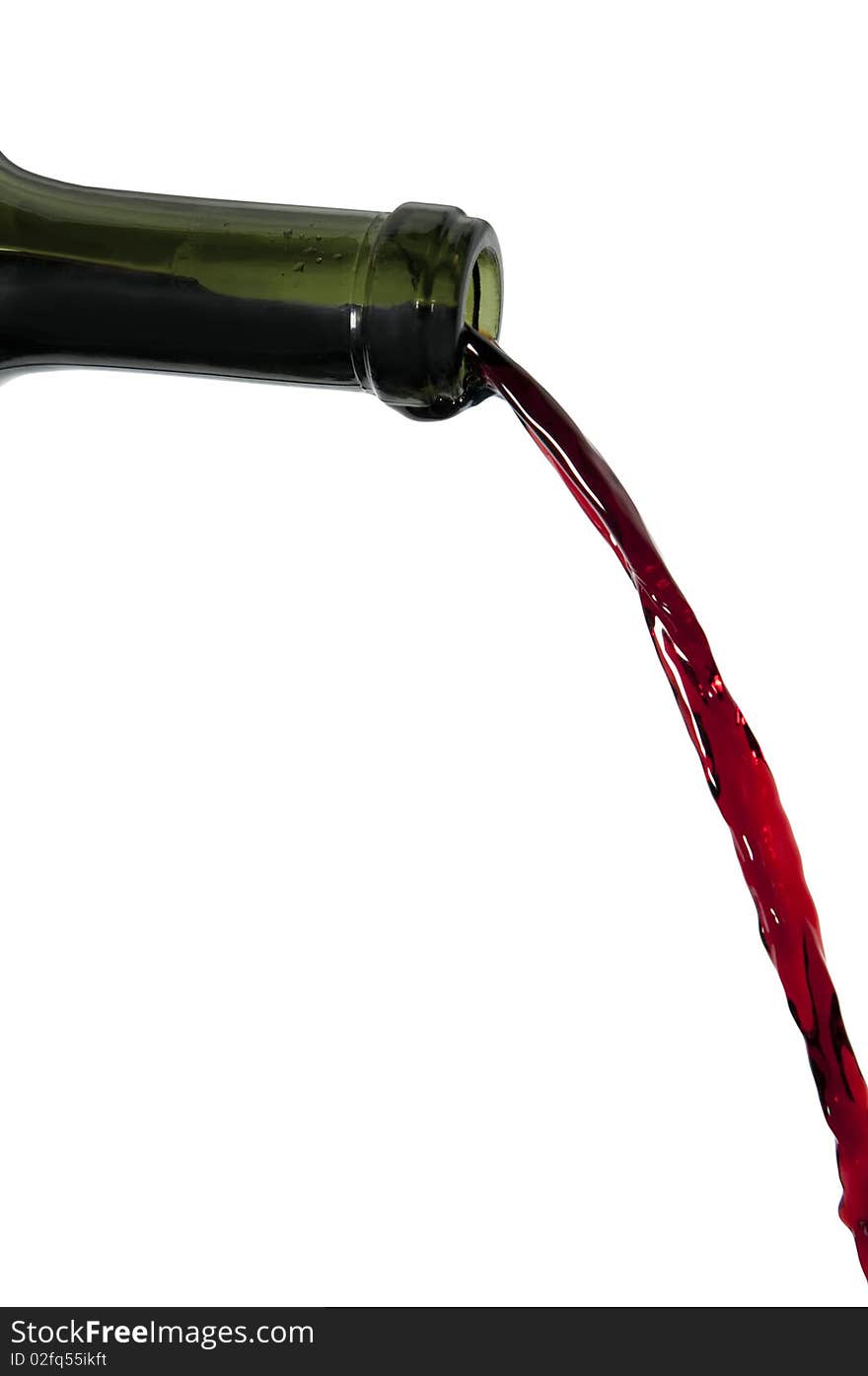 Red wine pouring out of bottle