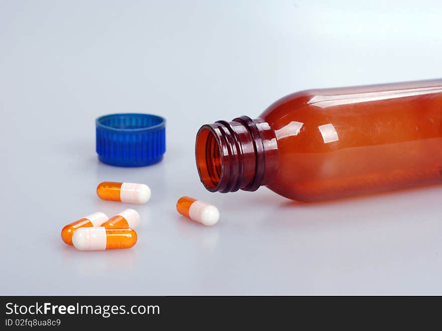 Macro shot of medicine capsules with bottle