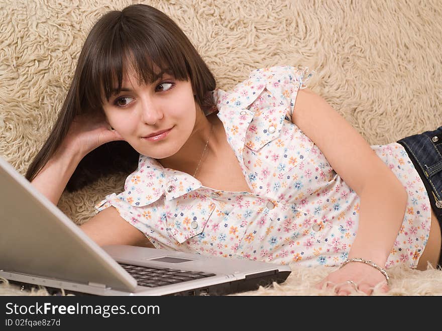 Beautiful young girl with a laptop on a white background. Beautiful young girl with a laptop on a white background