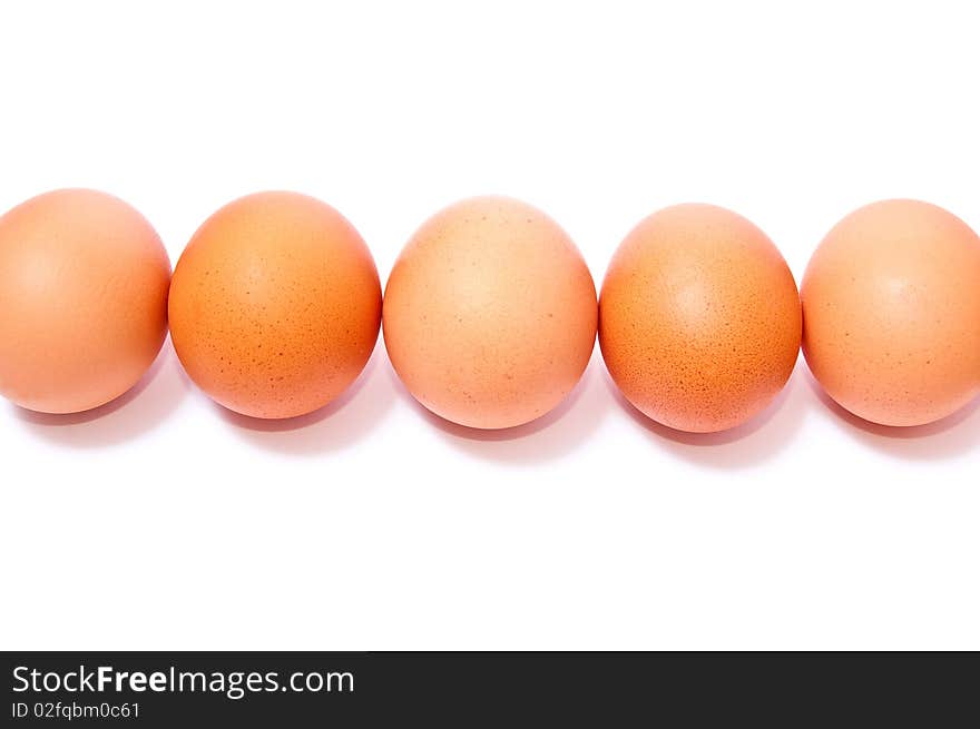 Row from brown eggs isolated on white background. Row from brown eggs isolated on white background