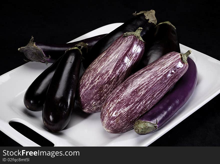 Eggplants arranged on a white dish. Eggplants arranged on a white dish.