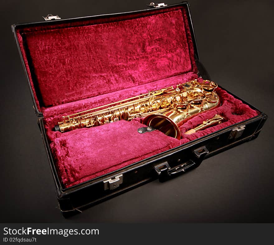 Golden saxophone in blabk case. Golden saxophone in blabk case