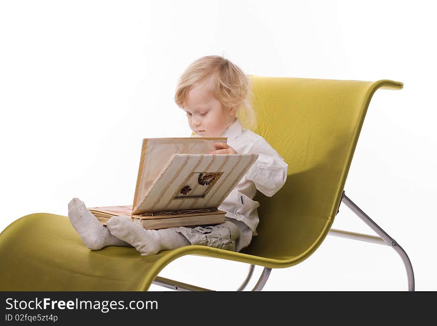 Little boy with book on white