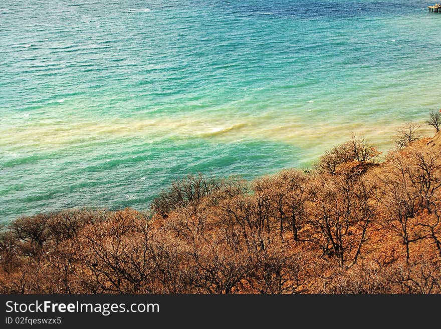 Sea view from the mountain slopes which are covered by forest. Sea view from the mountain slopes which are covered by forest.