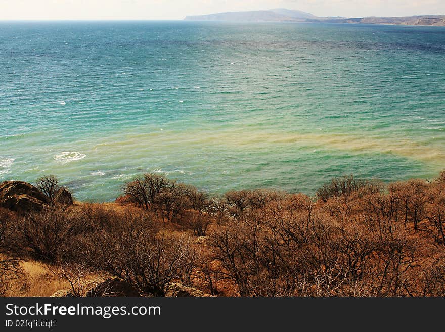 Sea view from the mountain slopes which are covered by forest. Sea view from the mountain slopes which are covered by forest.