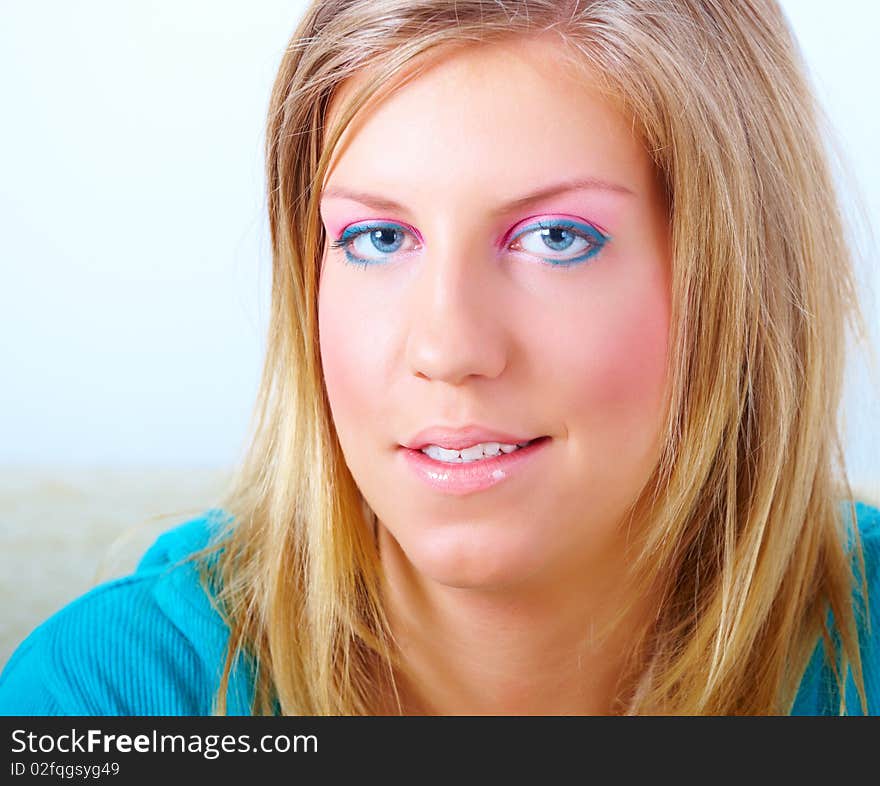 Portrait of young woman face with long blond hair and beautiful modern make-up. Portrait of young woman face with long blond hair and beautiful modern make-up.