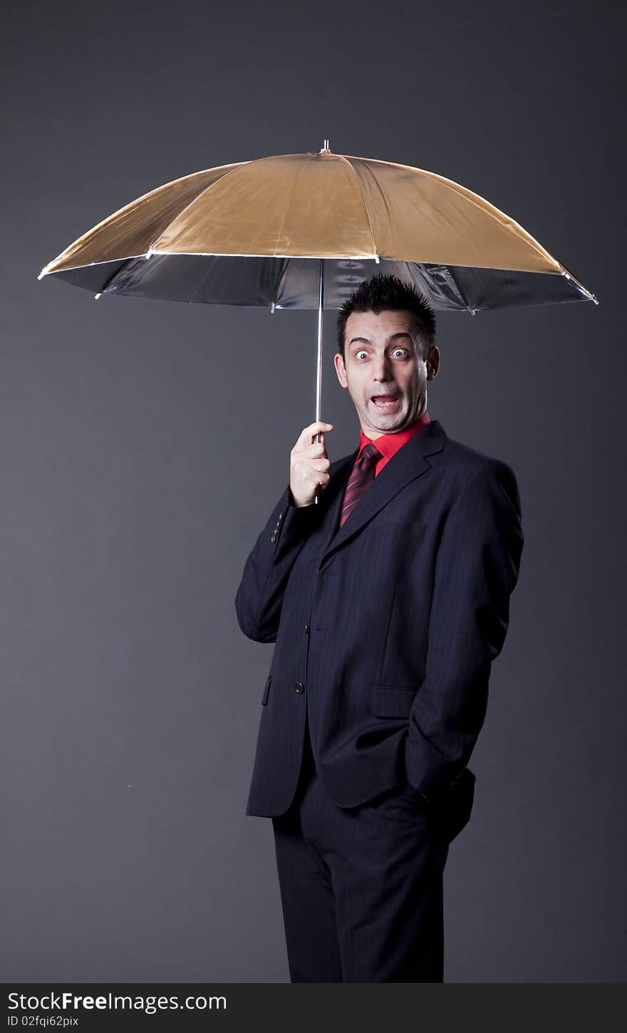 Young funny man with studio umbrella