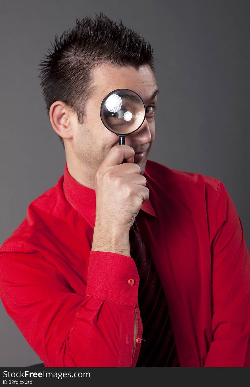 Funny businessman with magnifying glass