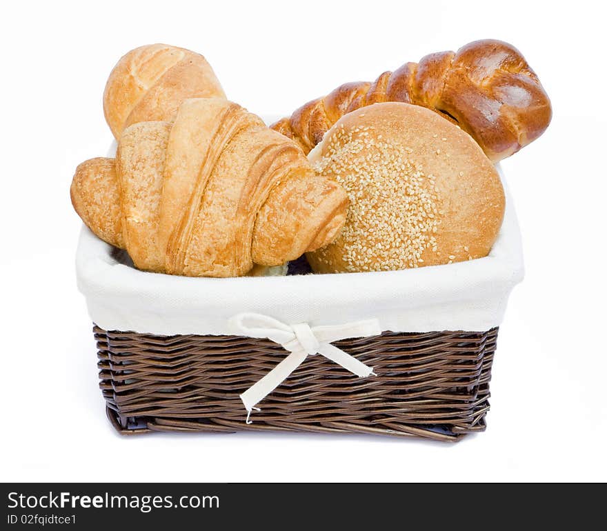 Fresh baked rolls in a basket on white. Fresh baked rolls in a basket on white