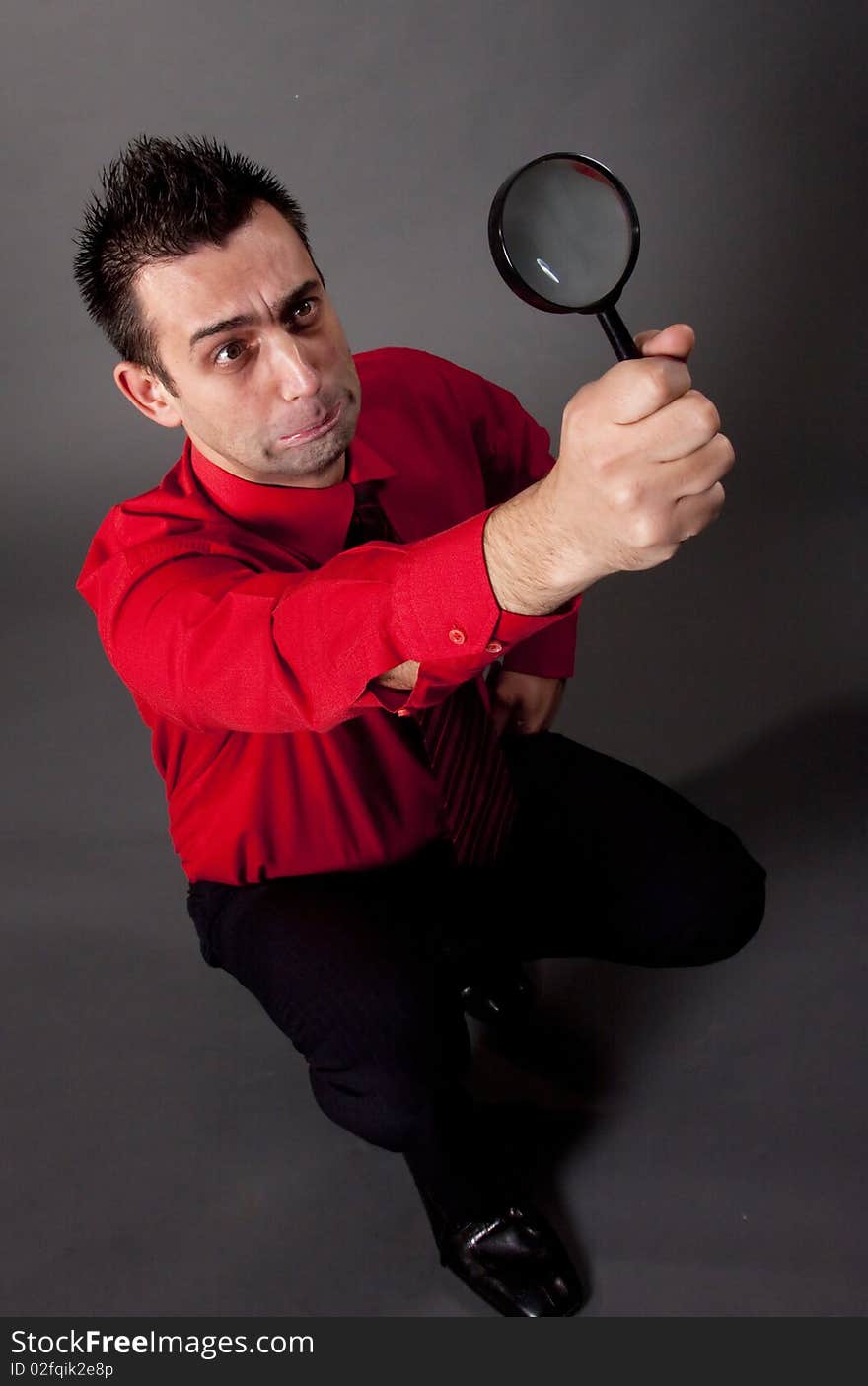 Funny businessman with magnifying glass