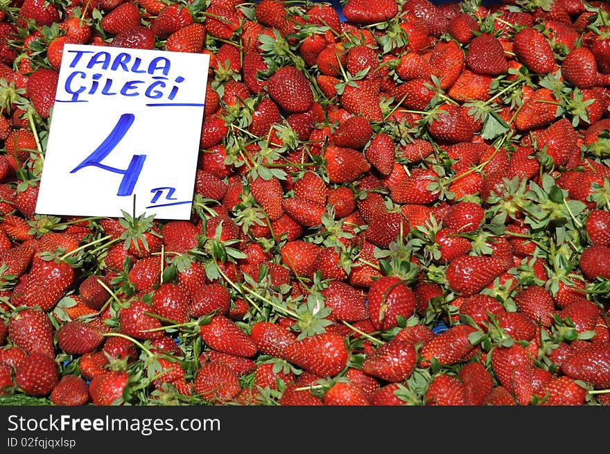 Strawberries on the market with pricetag. Strawberries on the market with pricetag