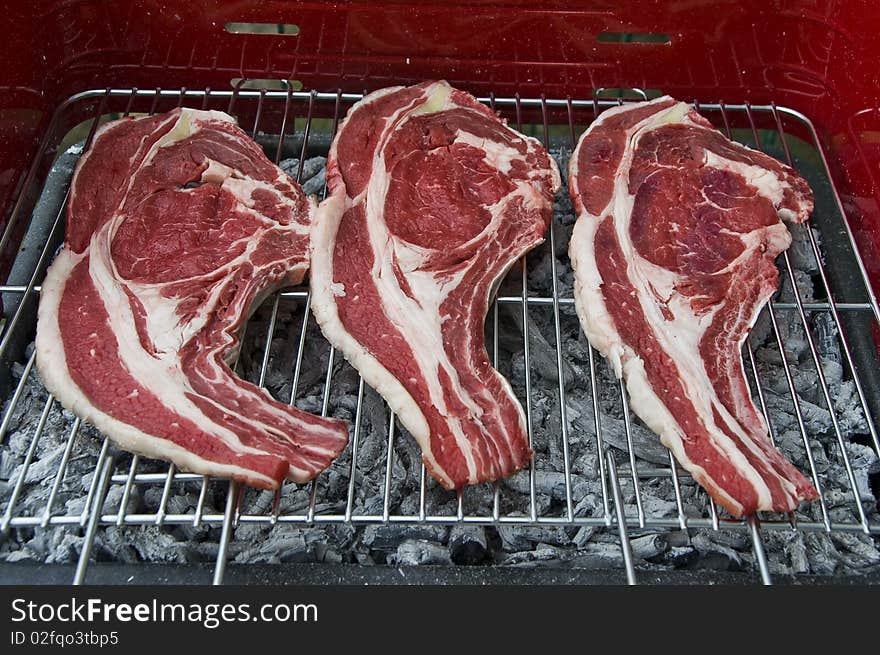 Some slices of beef on the grill. Some slices of beef on the grill