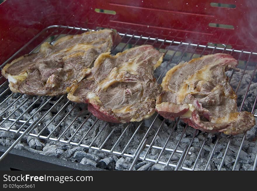 Some slices of beef on the grill. Some slices of beef on the grill