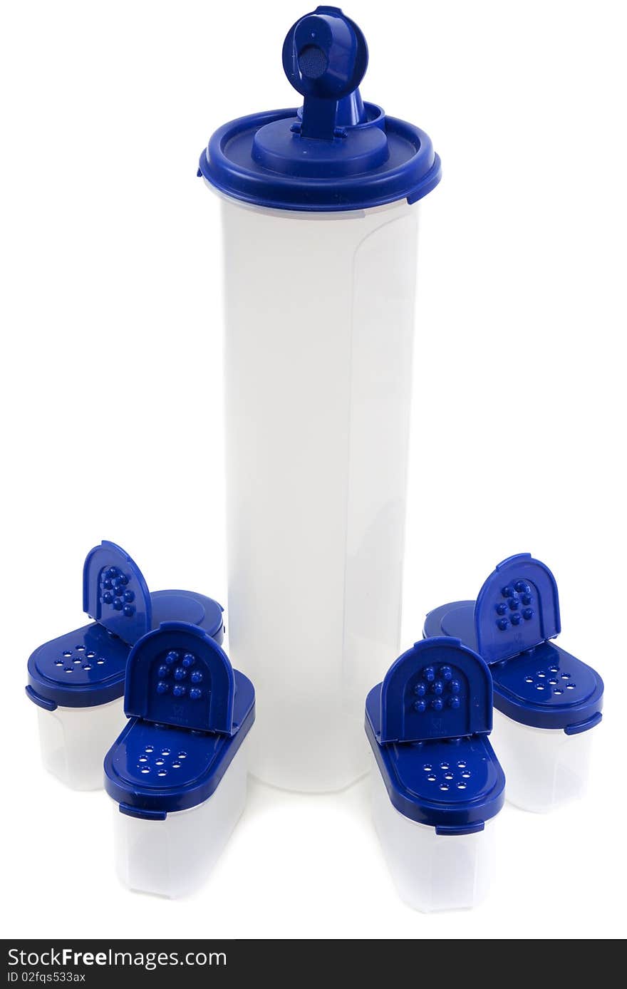 Saltcellar and plastic bottle from translucent plastic arts with blue lid on white background