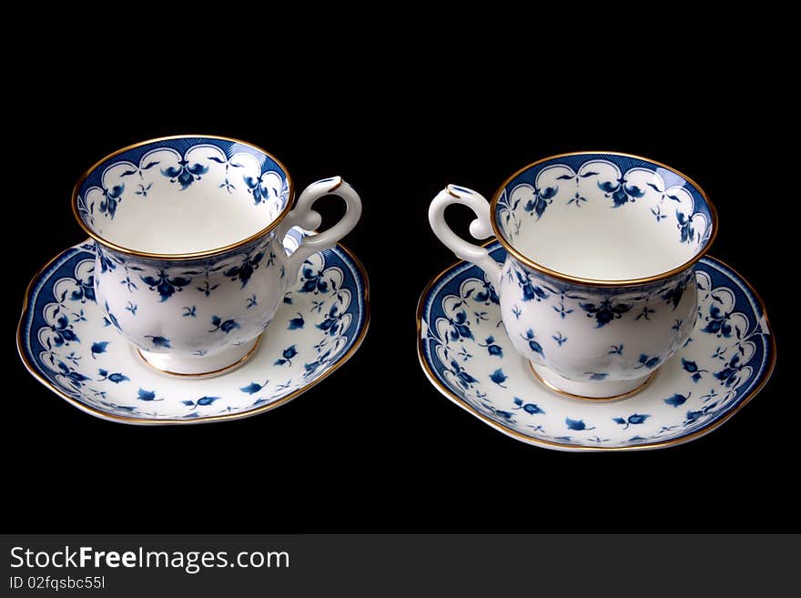 Two tea cups on saucer insulated on white background