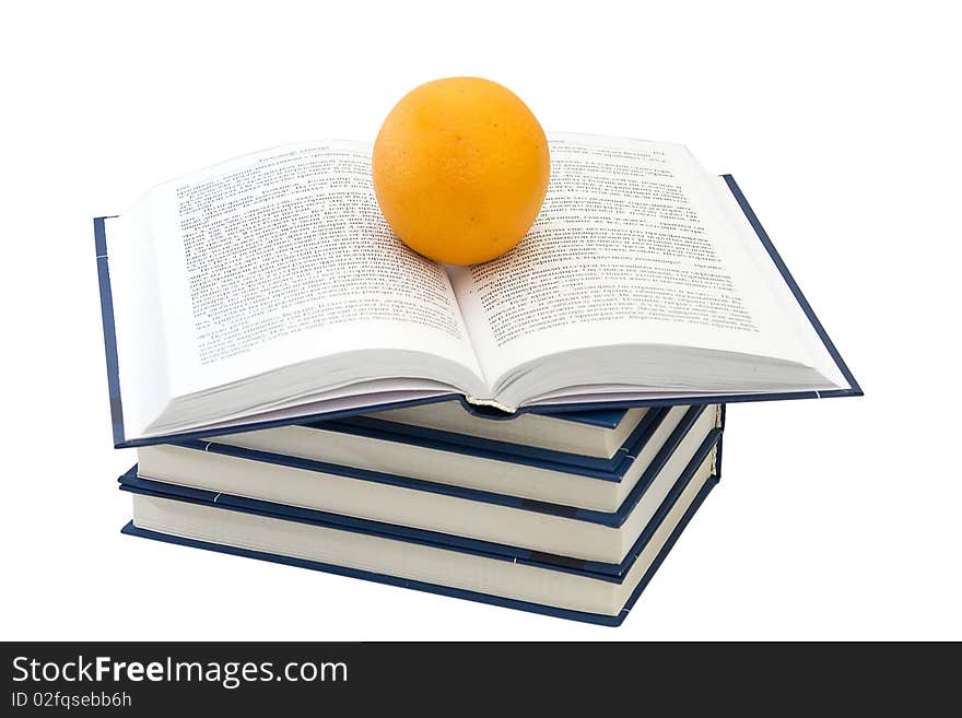 Pile of the books. The open book and orange. Pile of the books. The open book and orange