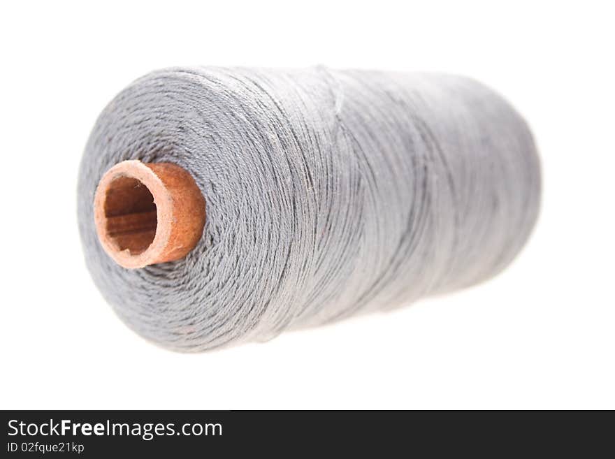 Large spools of thread on a white background