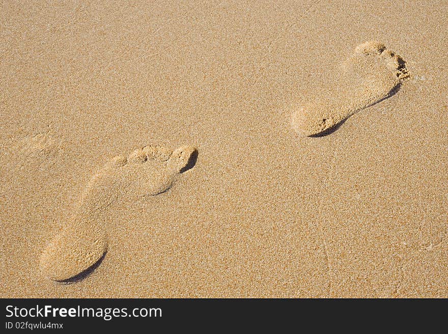 Pair of footprints in the sand