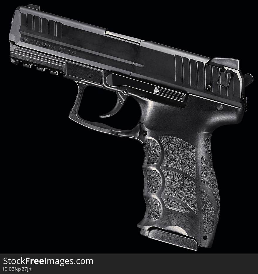 Heckler, automatic handgun isolated on a black background.