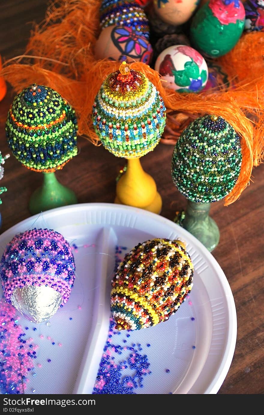 Several wooden easter eggs with beads wickework