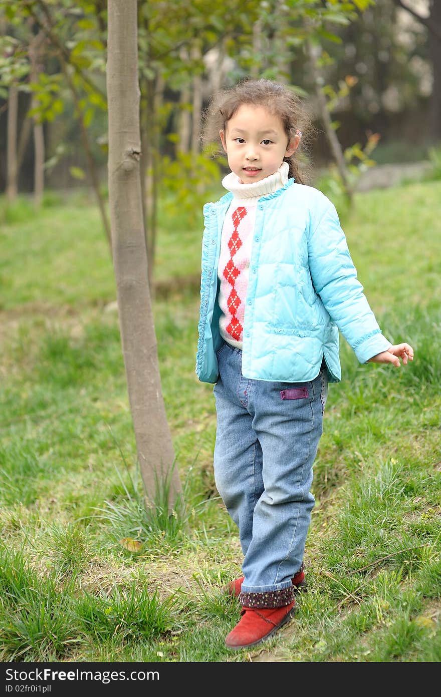 Cute little asian girl on green grass. Cute little asian girl on green grass.