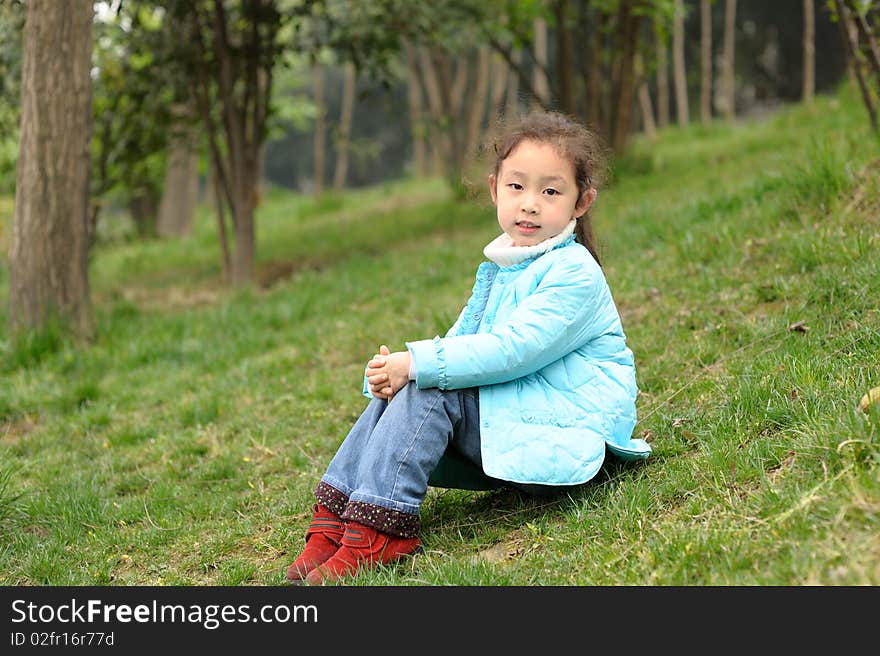 Cute little asian girl on grass