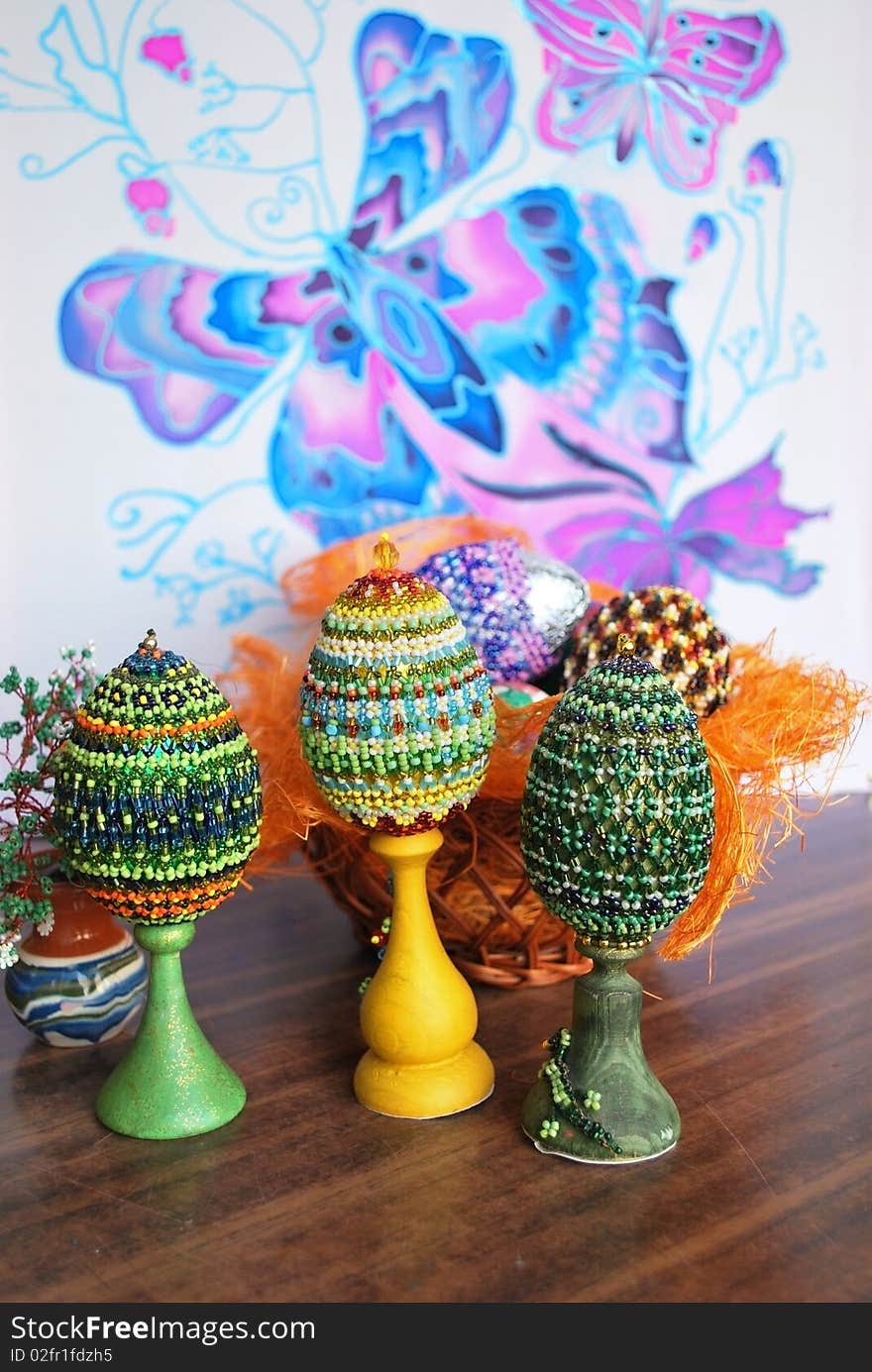 Several wooden easter eggs with beads wickework