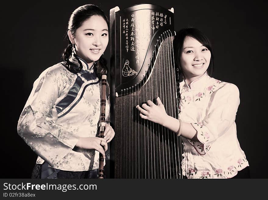 Two Chinese musicians with bamboo flute and zither on dark.


Chinese character on zither is Chinese Tang poetry,also a famous Tang Dynasty poet's calligraphy. It praised the unique charm of the zither. Two Chinese musicians with bamboo flute and zither on dark.


Chinese character on zither is Chinese Tang poetry,also a famous Tang Dynasty poet's calligraphy. It praised the unique charm of the zither.