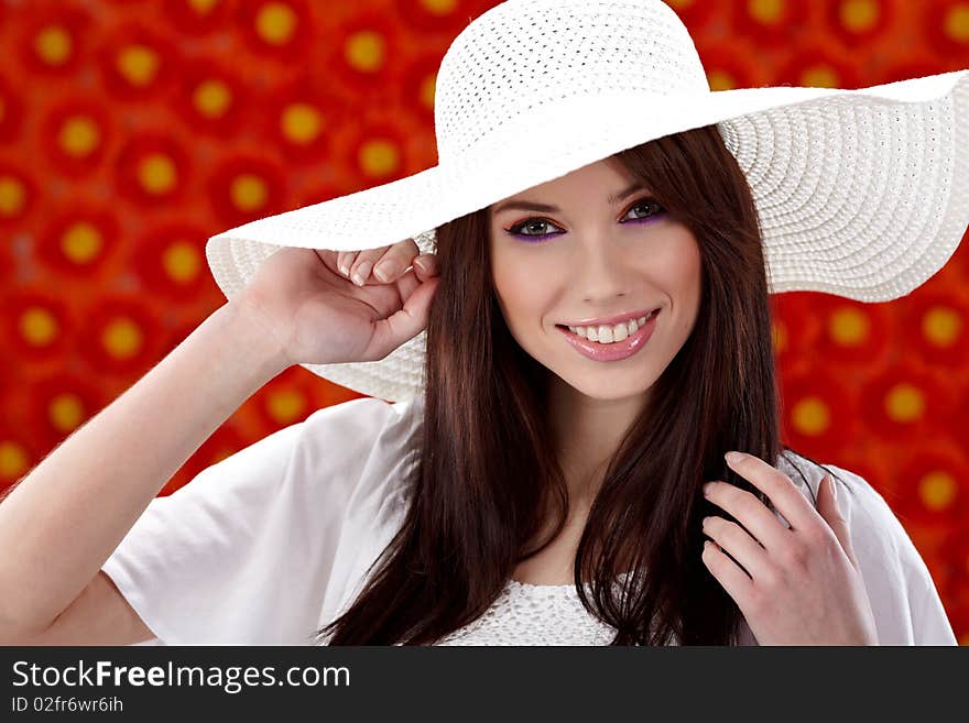 Summer woman over red flowers wall