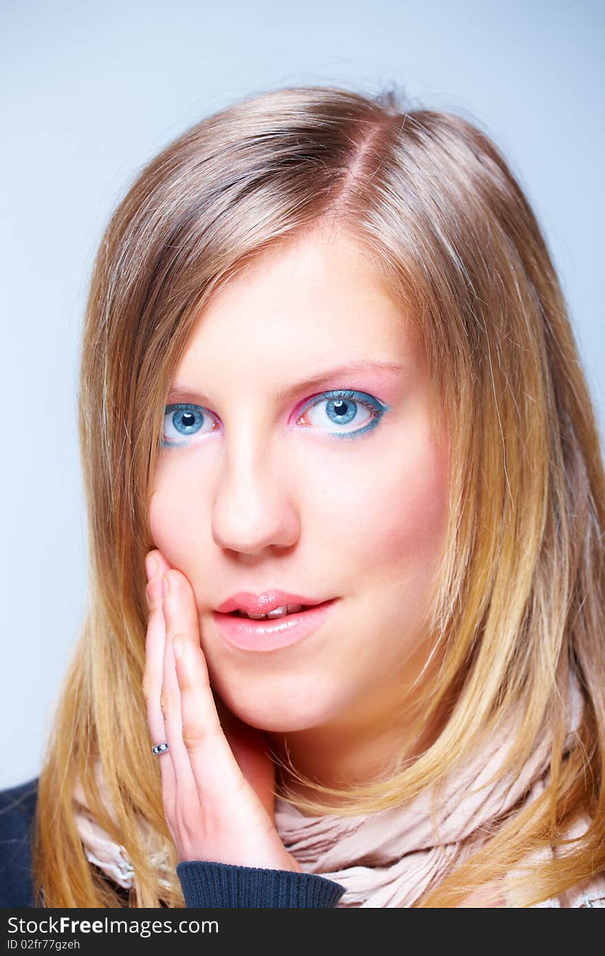 Portrait of young woman face with long blond hair and beautiful modern make-up, surprised expression. Portrait of young woman face with long blond hair and beautiful modern make-up, surprised expression.