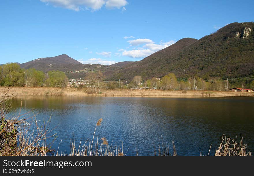 A boggy and sunny landscape with mountains. A boggy and sunny landscape with mountains