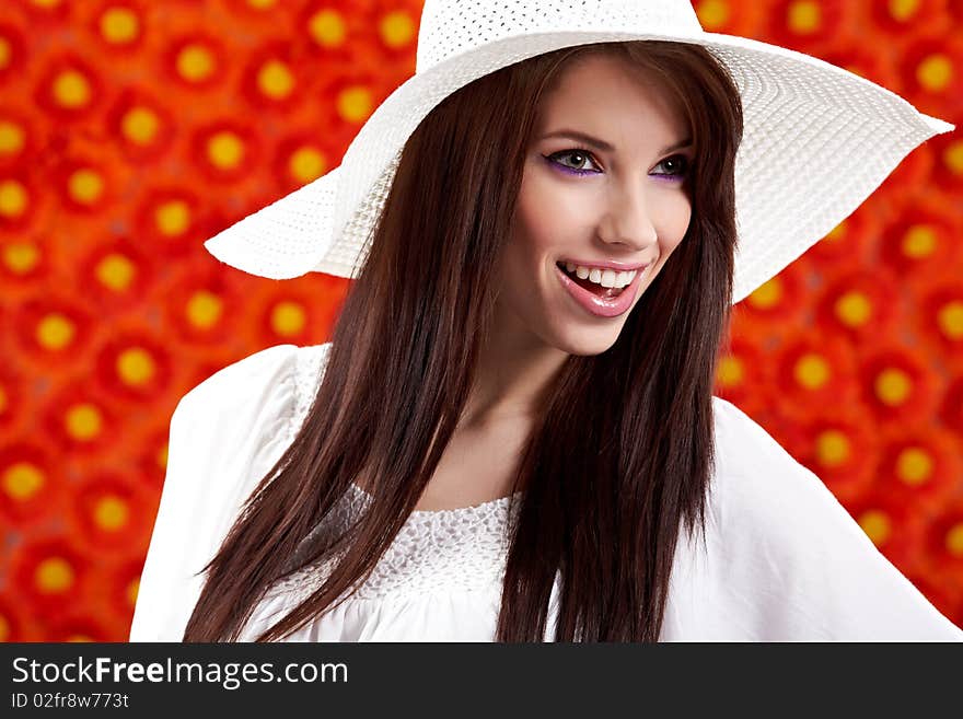 Summer woman over red flowers wall