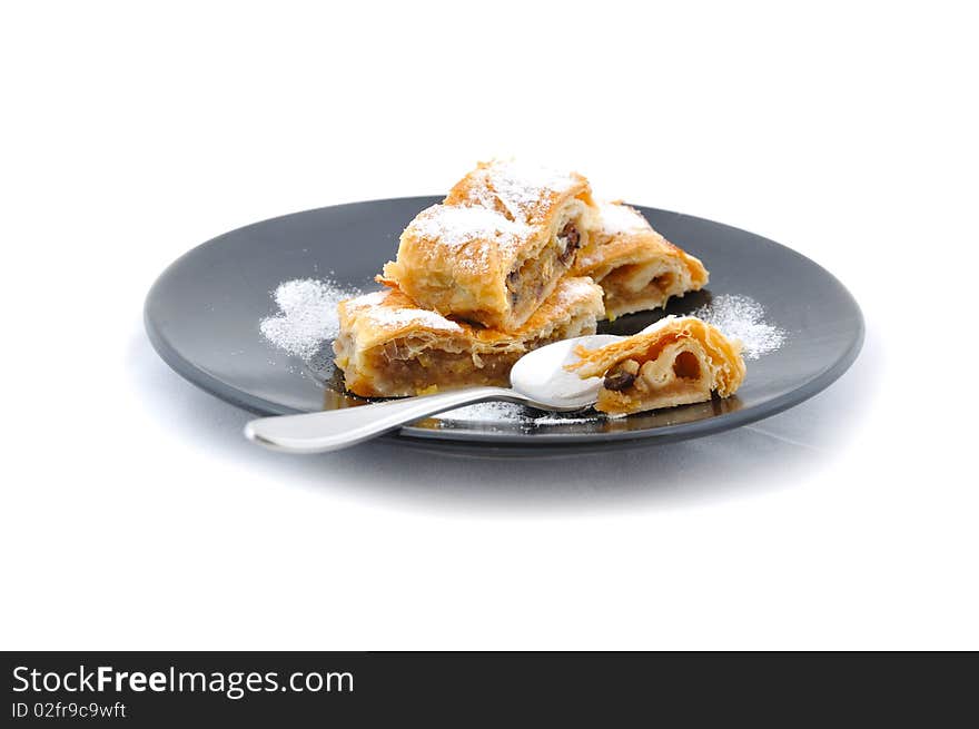 Czech apple pie on black plate with spoon. Czech apple pie on black plate with spoon