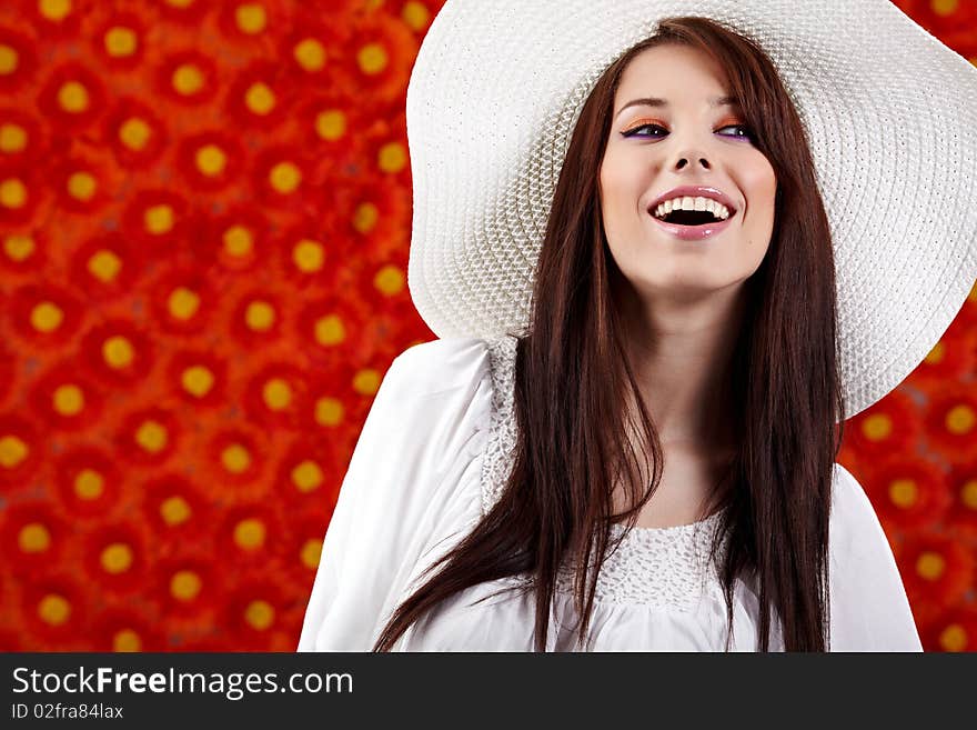 Summer woman over red flowers wall