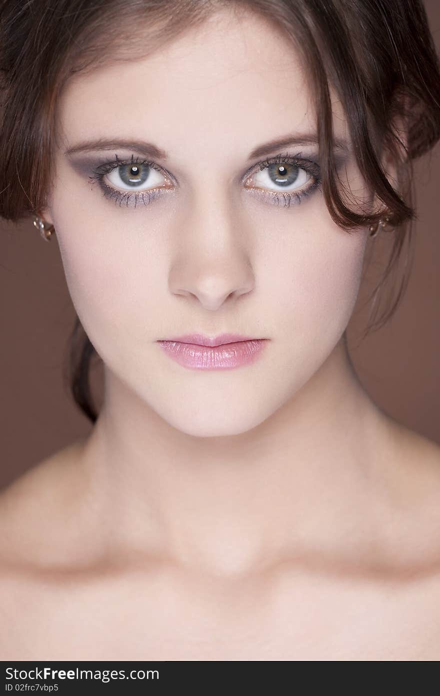 Close up portrait of beautiful young woman on brown background. Close up portrait of beautiful young woman on brown background