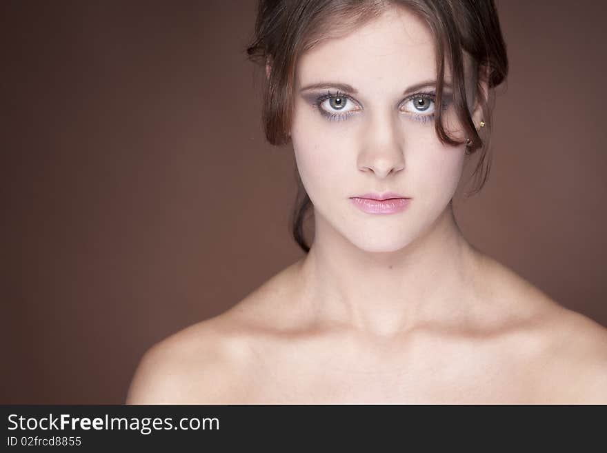 Beautiful young woman on brown background. Beautiful young woman on brown background