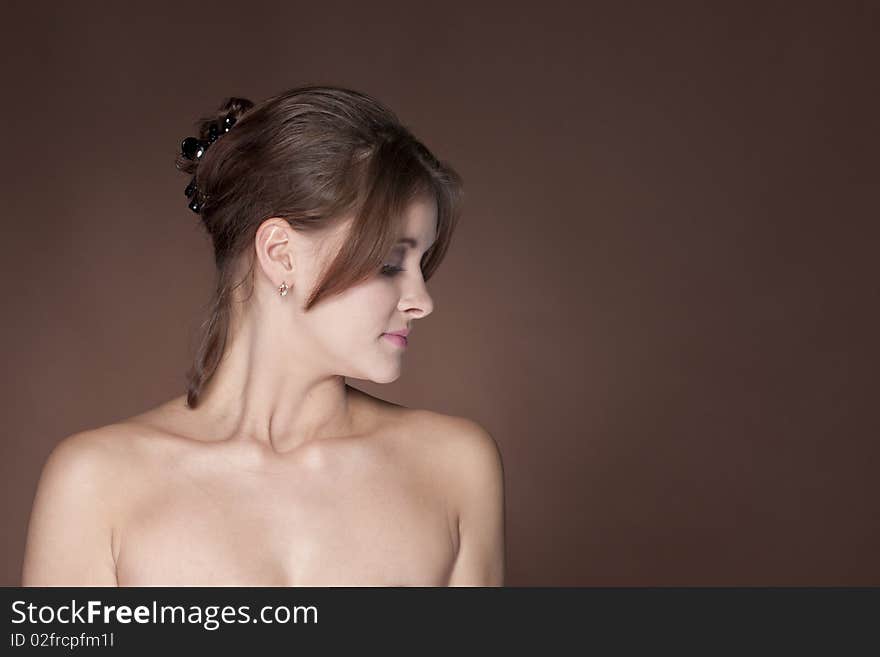 Beautiful young female face on brown background. Beautiful young female face on brown background