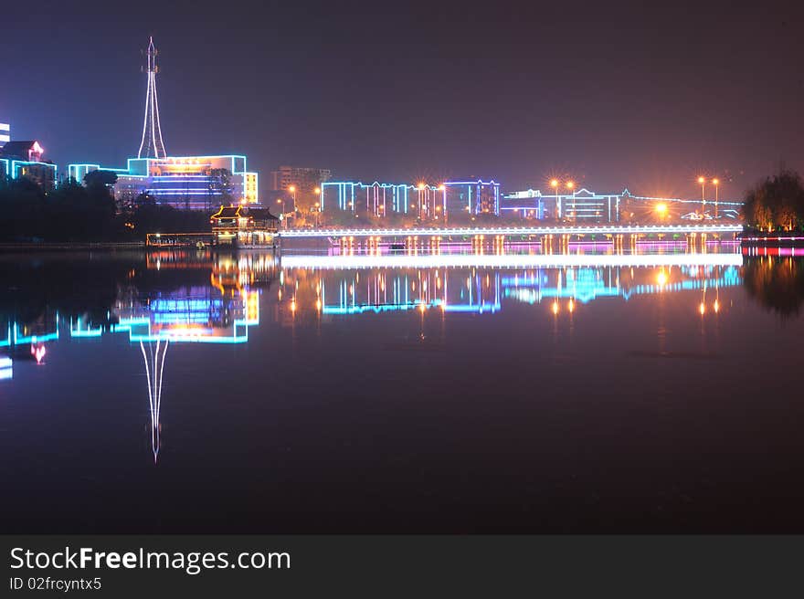 City by water at night in china.