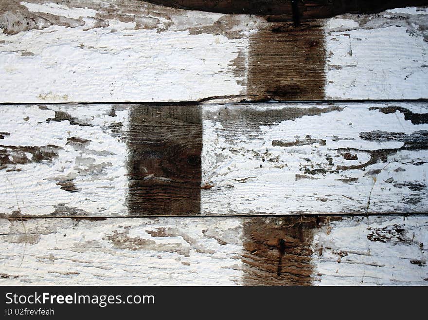 White-washed old floorboards of a barn with peeling paint and signs of age. White-washed old floorboards of a barn with peeling paint and signs of age.