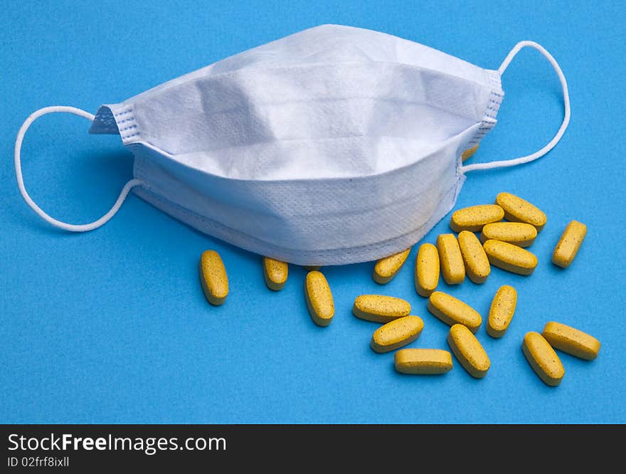 Surgical mask and pills for a health care concept. Surgical mask and pills for a health care concept.