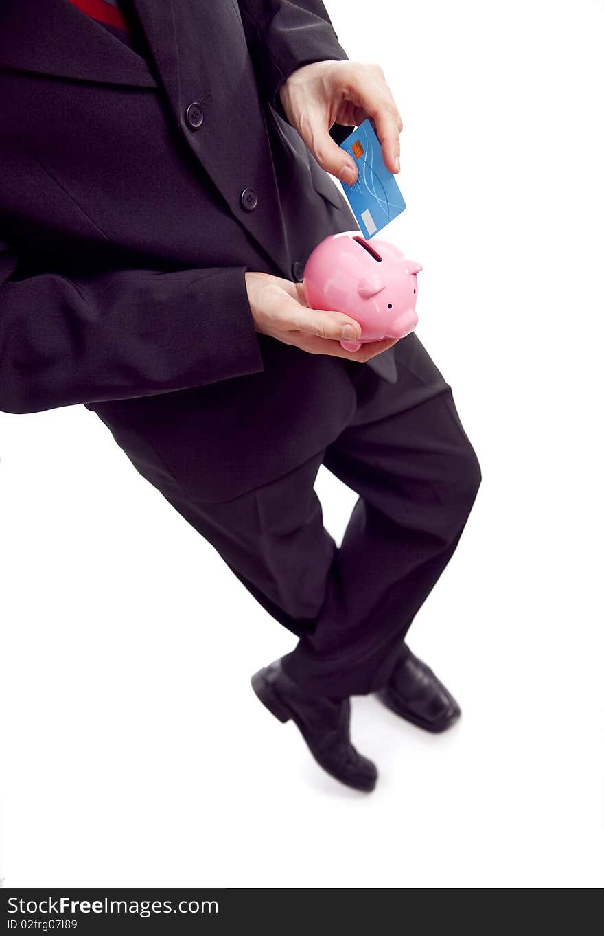 Businessman holding piggy bank and credit card. Businessman holding piggy bank and credit card