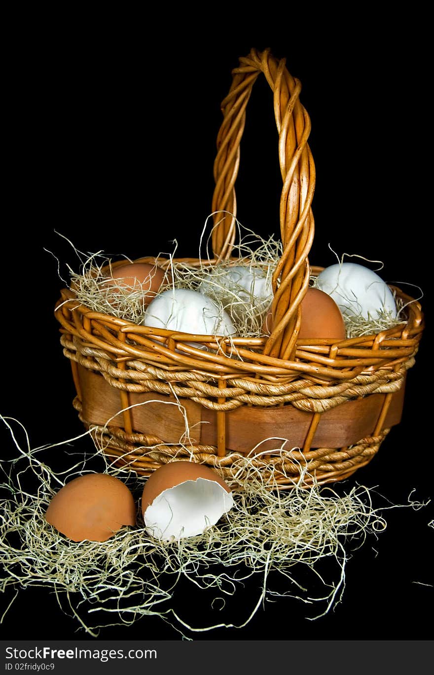 Brown and white eggs in a wicker basket. Brown and white eggs in a wicker basket.