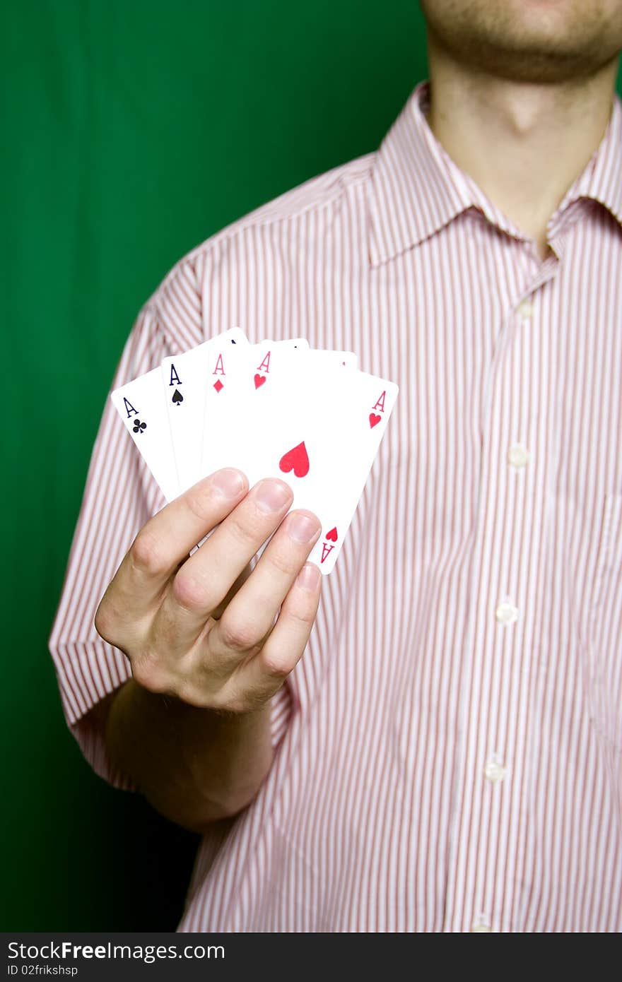 A young man in a red striped shirt, holding four aces. A young man in a red striped shirt, holding four aces