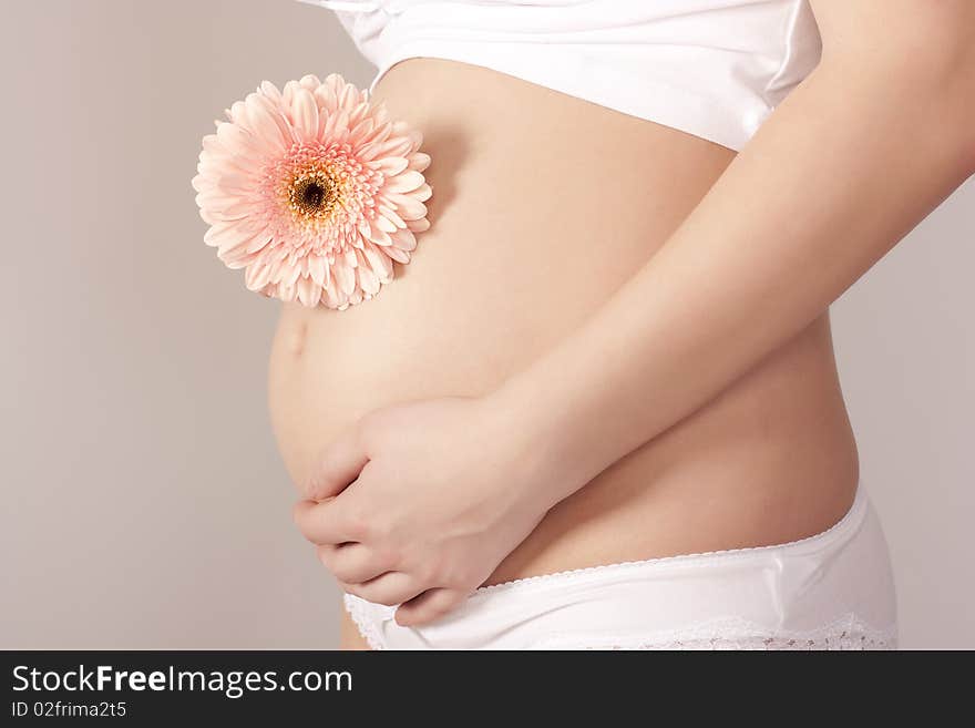 Pregnant woman with pink flower